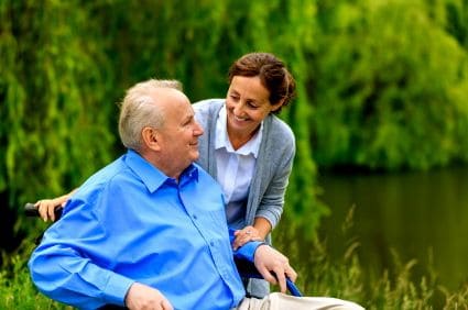 Senior man in a wheelchair with a respite caregiver
